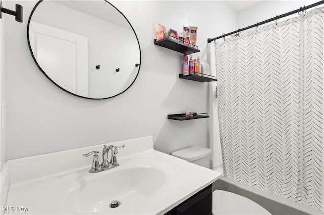 full bathroom featuring shower / tub combo, toilet, and vanity