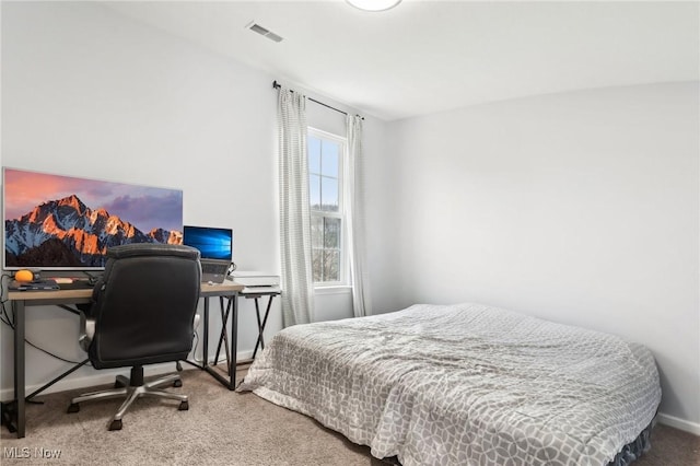 bedroom with carpet floors, visible vents, and baseboards