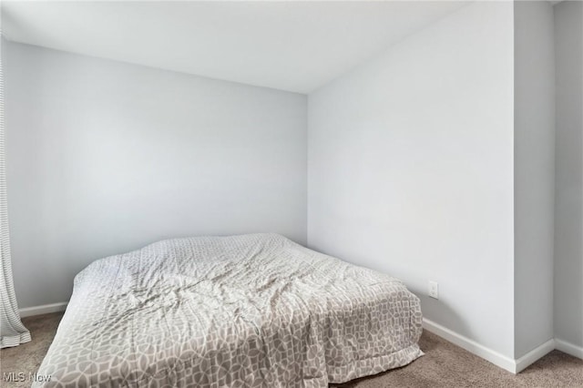 bedroom with carpet floors and baseboards