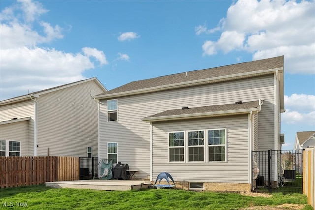 back of house featuring fence, a yard, and a patio