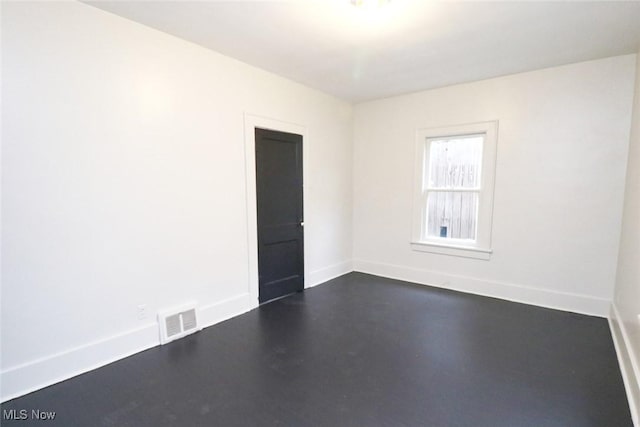 unfurnished room featuring visible vents and baseboards