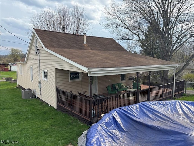101 Sunset Ln, Follansbee, WV 26037 - rear view of house featuring an outdoor living space, a lawn, central air condition unit, a shingled roof, and fence