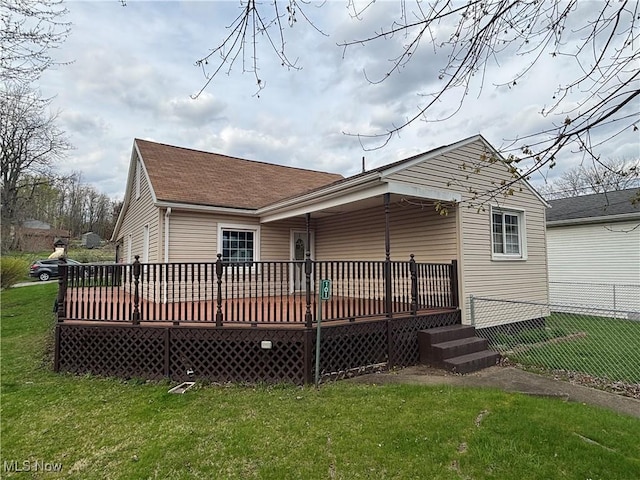 101 Sunset Ln, Follansbee, WV 26037 - rear view of property featuring a yard, a shingled roof, fence, and a deck