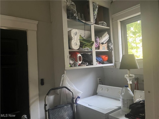 clothes washing area with washer and clothes dryer and laundry area