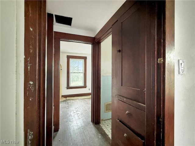 corridor featuring light wood-style floors and visible vents