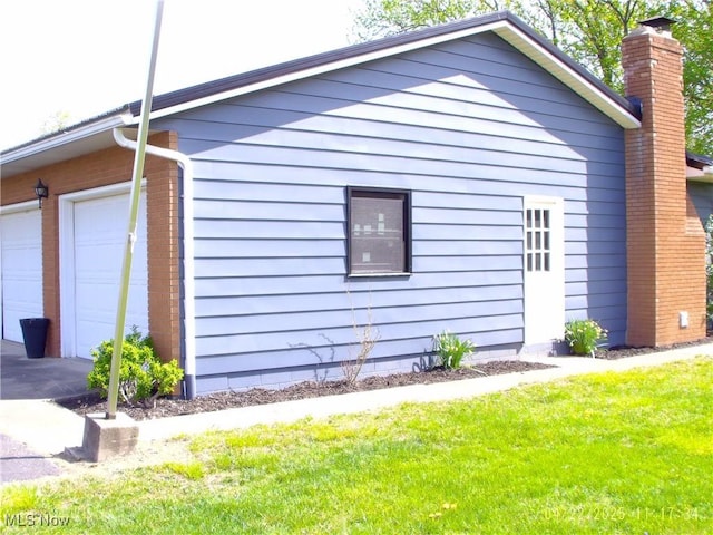 view of home's exterior featuring a lawn and a chimney
