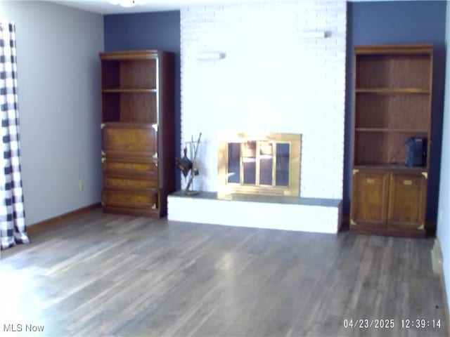 living area with wood finished floors and baseboards
