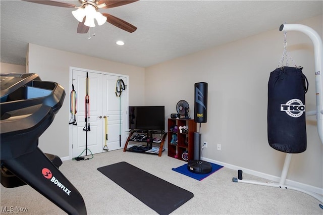 workout room with baseboards, carpet floors, and ceiling fan