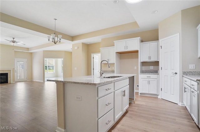 9264 Sharrott Rd Unit 1002, Poland, OH 44514 - kitchen with light wood-style floors, white cabinetry, open floor plan, a ceiling fan, and an island with sink