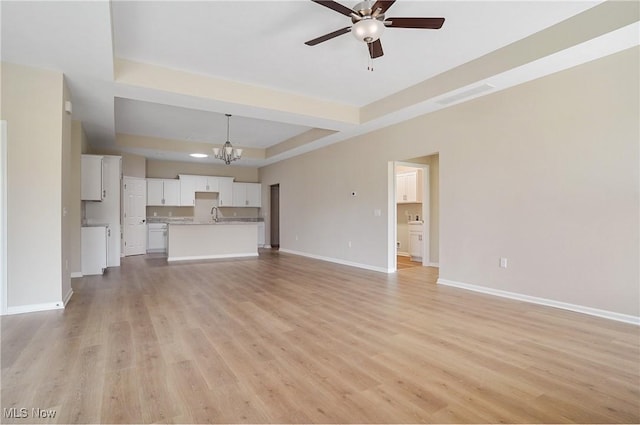 9264 Sharrott Rd Unit 1002, Poland, OH 44514 - unfurnished living room with a tray ceiling, ceiling fan, a chandelier, light wood-style flooring, and recessed lighting