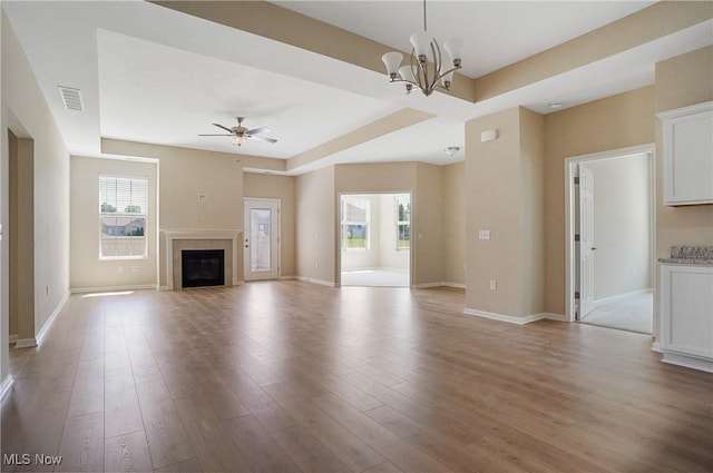 9264 Sharrott Rd Unit 1002, Poland, OH 44514 - unfurnished living room featuring plenty of natural light, light wood finished floors, a chandelier, and ceiling fan