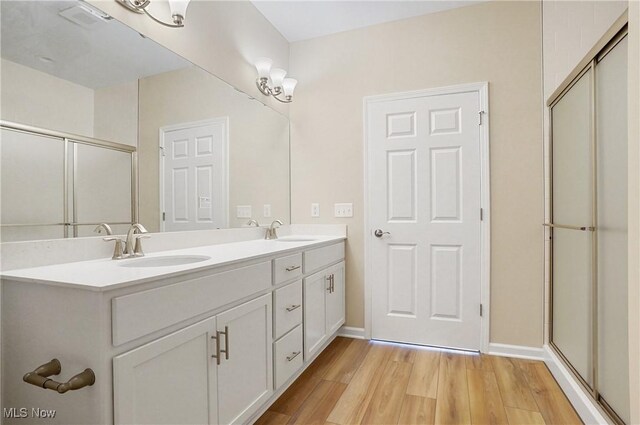9264 Sharrott Rd Unit 1002, Poland, OH 44514 - full bathroom with wood finished floors, double vanity, and a shower with shower door