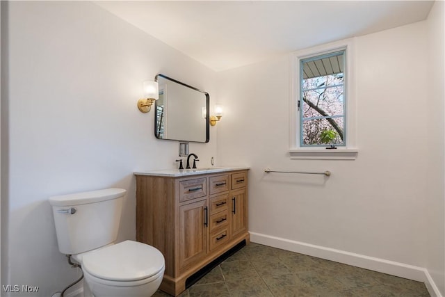 2622 Glenmont Rd NW, Canton, OH 44708 - bathroom featuring vanity, toilet, baseboards, and tile patterned floors