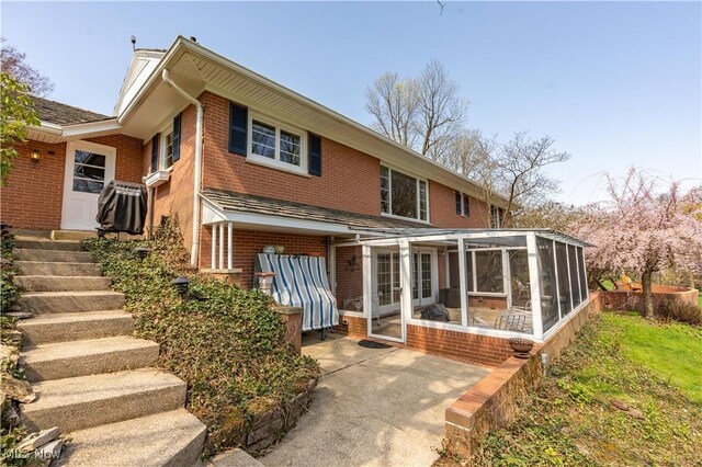 2622 Glenmont Rd NW, Canton, OH 44708 - back of property with brick siding and a sunroom