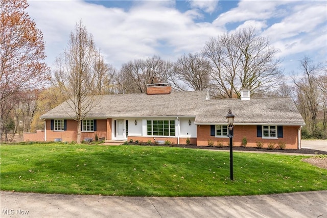 2622 Glenmont Rd NW, Canton, OH 44708 - ranch-style house with a chimney, a front lawn, and brick siding