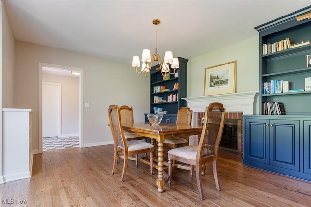 2622 Glenmont Rd NW, Canton, OH 44708 - dining space featuring an inviting chandelier, built in features, wood finished floors, and baseboards