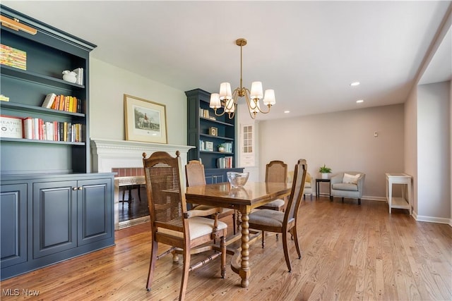 2622 Glenmont Rd NW, Canton, OH 44708 - dining room with built in shelves, baseboards, a notable chandelier, and light wood finished floors