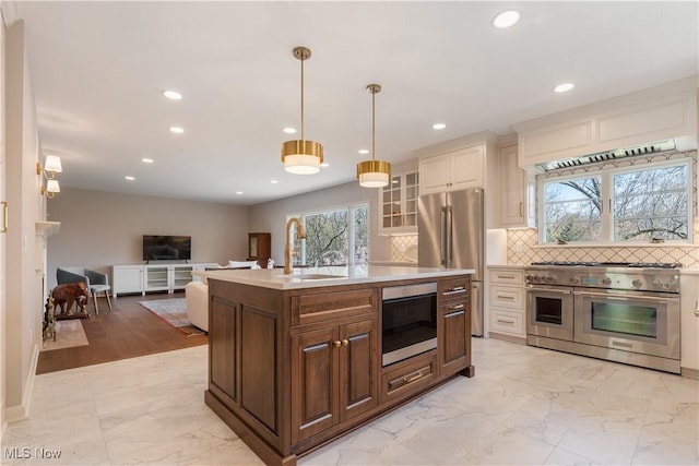 2622 Glenmont Rd NW, Canton, OH 44708 - kitchen with a sink, marble finish floor, stainless steel appliances, light countertops, and recessed lighting