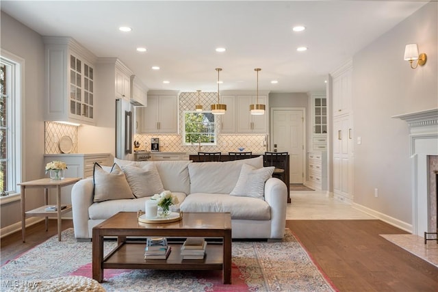 2622 Glenmont Rd NW, Canton, OH 44708 - living room featuring baseboards, light wood-style flooring, and recessed lighting