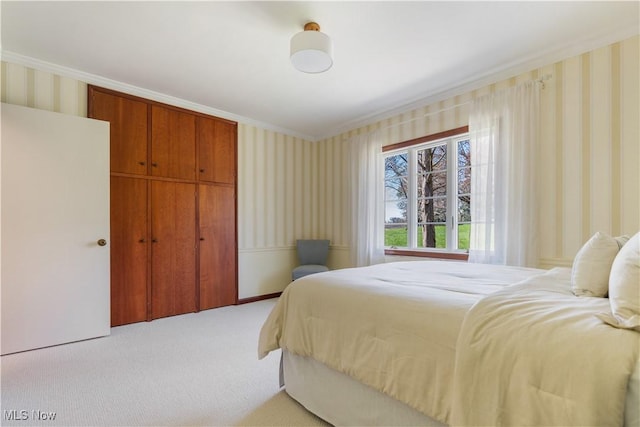 2622 Glenmont Rd NW, Canton, OH 44708 - bedroom featuring light colored carpet, ornamental molding, wallpapered walls, and a closet