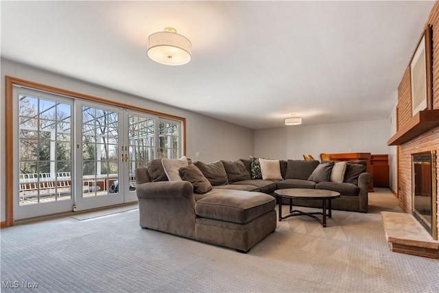 2622 Glenmont Rd NW, Canton, OH 44708 - living area with a brick fireplace, a wealth of natural light, and light colored carpet
