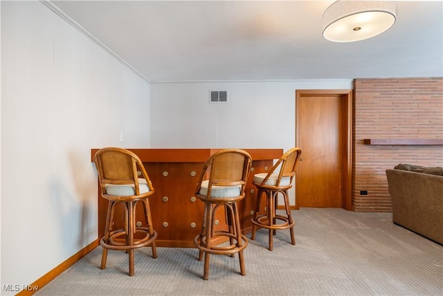 2622 Glenmont Rd NW, Canton, OH 44708 - interior space featuring visible vents, carpet flooring, ornamental molding, and a bar