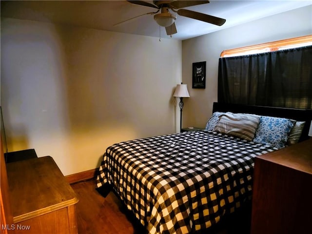 bedroom featuring baseboards, a ceiling fan, and wood finished floors