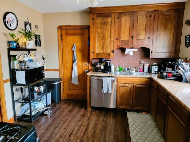 kitchen with light countertops, dark wood finished floors, stainless steel dishwasher, and a sink