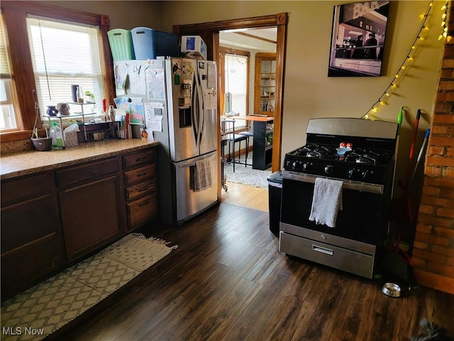 kitchen with dark wood-type flooring and appliances with stainless steel finishes