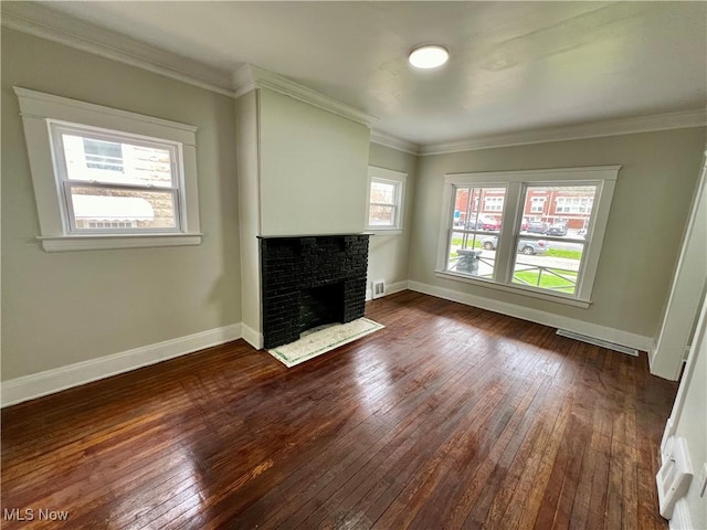 3478 E 150th St, Cleveland, OH 44120 - unfurnished living room featuring dark wood-style floors, crown molding, a fireplace, baseboards, and visible vents