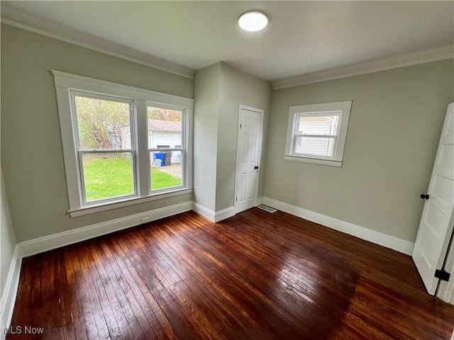 3478 E 150th St, Cleveland, OH 44120 - unfurnished bedroom with ornamental molding, baseboards, dark wood-style flooring, and visible vents