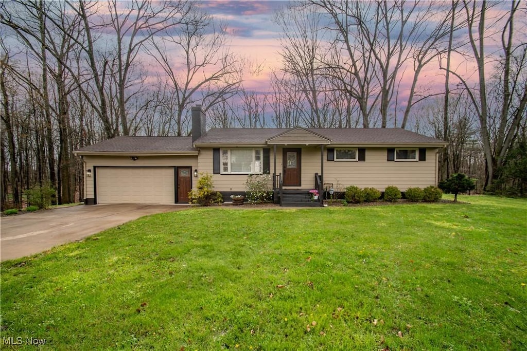 2690 S Turner Rd, Canfield, OH 44406 - ranch-style house with a lawn, driveway, a chimney, and a garage
