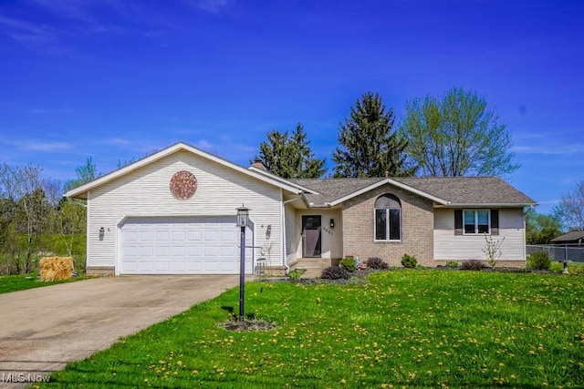ranch-style house featuring an attached garage, a front yard, and concrete driveway