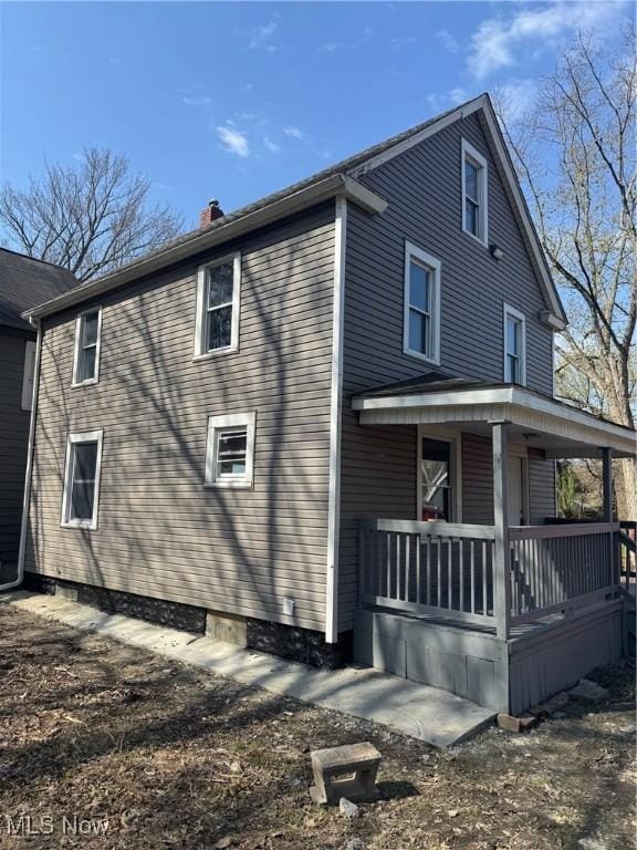 625 Allyn St, Akron, OH 44311 - view of home's exterior featuring a porch and a chimney