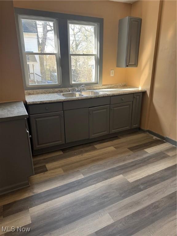 625 Allyn St, Akron, OH 44311 - kitchen featuring light countertops, a sink, dark wood-type flooring, and gray cabinets