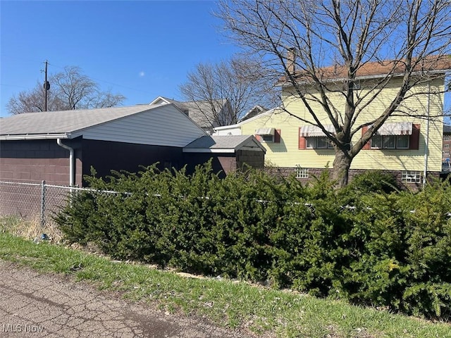 view of side of home with fence