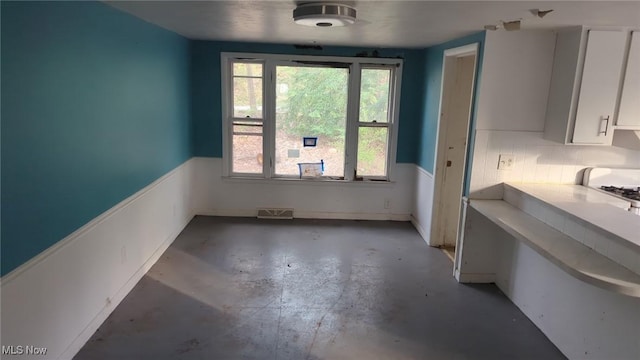 315 Loma Dr, Akron, OH 44319 - unfurnished dining area featuring concrete flooring and visible vents