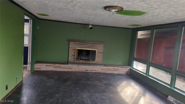 315 Loma Dr, Akron, OH 44319 - unfurnished living room featuring baseboards, a brick fireplace, and a textured ceiling