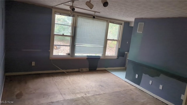 315 Loma Dr, Akron, OH 44319 - unfurnished room featuring baseboards, a textured ceiling, and plenty of natural light