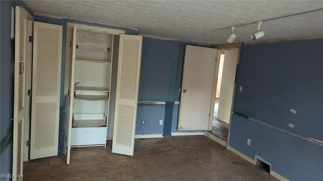 315 Loma Dr, Akron, OH 44319 - unfurnished bedroom with rail lighting, baseboards, and a textured ceiling