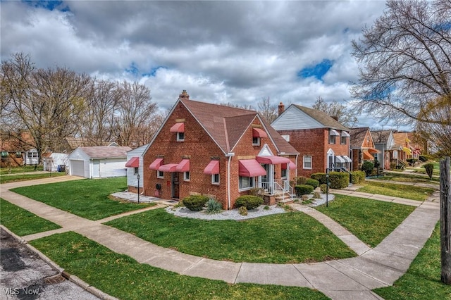 view of front facade featuring brick siding, a residential view, a front lawn, and a garage