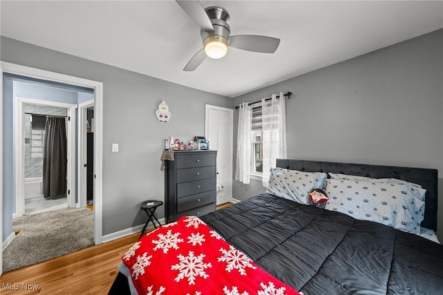 bedroom featuring baseboards, a ceiling fan, wood finished floors, and a closet