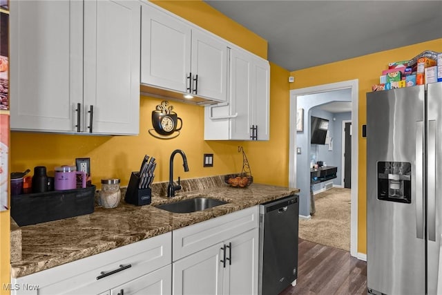 kitchen featuring white cabinetry, stainless steel appliances, dark wood-type flooring, and a sink