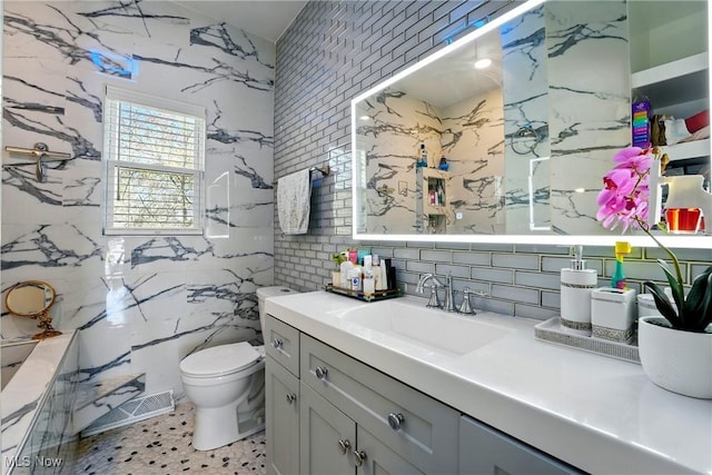 3270 S Canfield Niles Rd, Canfield, OH 44406 - bathroom featuring backsplash, visible vents, toilet, vanity, and tile walls