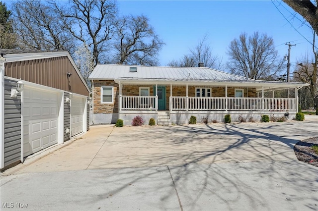 3270 S Canfield Niles Rd, Canfield, OH 44406 - view of front facade with driveway, metal roof, a porch, an outbuilding, and a garage