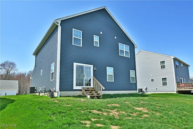 back of house with central AC unit, a yard, and entry steps