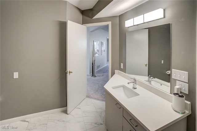 bathroom featuring marble finish floors, baseboards, and vanity