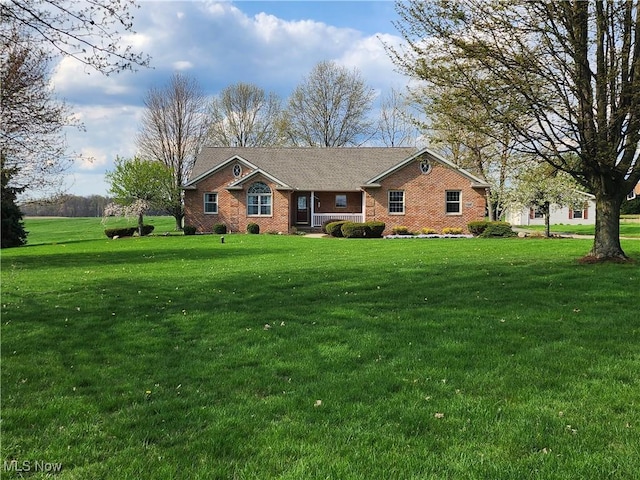 ranch-style house featuring a front lawn and brick siding