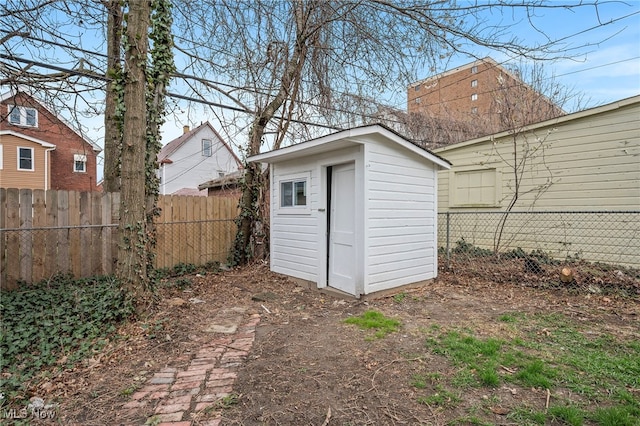 view of shed featuring fence
