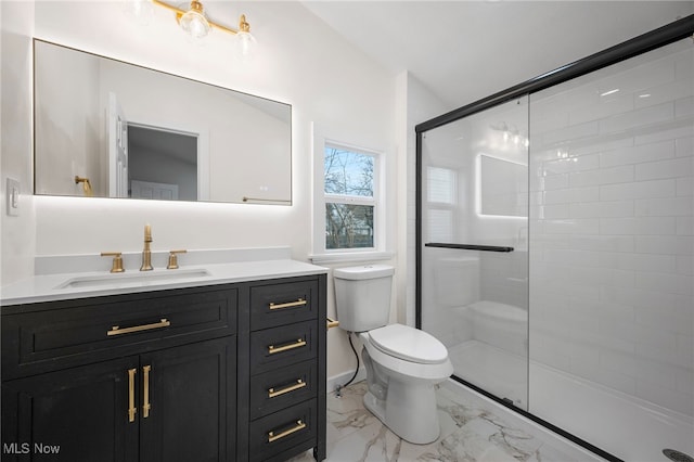 bathroom featuring toilet, marble finish floor, vanity, and a stall shower